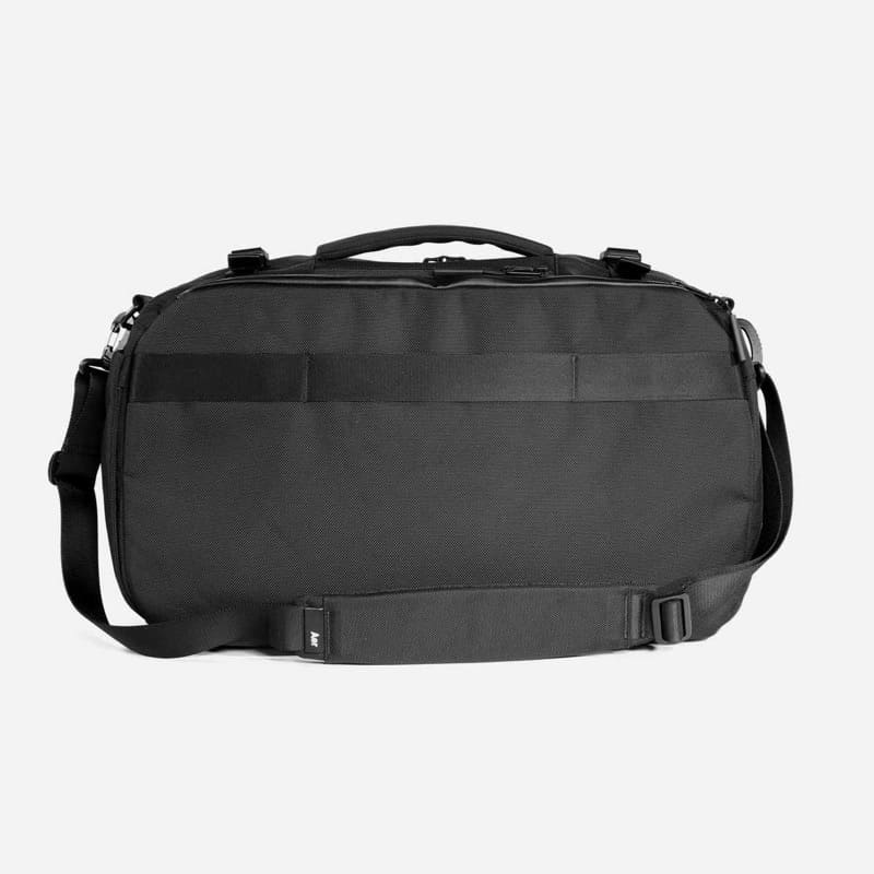 Aer Travel Duffel Back panel has luggage pass through. Shoulder strap is satisfactory.